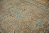 Distressed antique Mahal carpet detail, showing worn powder blue floral palmettes on a beige field.