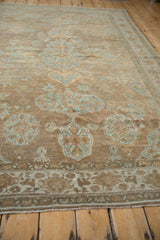 Distressed antique Mahal carpet, faded powder blue palmettes on dusty mauve, showing wear.
