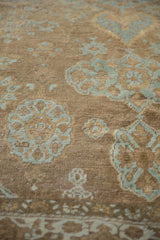 Detailed view of antique Mahal rug pile with worn powder blue floral motifs.