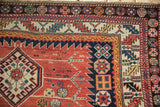 Intricate serrated leaf and floral top-view borders on an antique hand-knotted Caucasian rug.