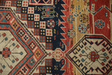 Detailed checkered fills and serrated geometric patterns in navy, red, and saffron on an antique Caucasian rug.