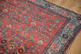 Vintage Malayer rug: vivid powder blue border of floral vines and brick red Herati field.