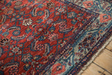 Vintage Malayer rug corner, fringe, showing geometric vines and brick red, dusty teal.