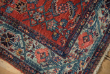 Vintage Malayer rug corner: brick red Herati field, powder blue floral border, natural fringe.