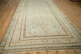 Antique distressed Malayer carpet displaying faded beige, powder blue Herati pattern, with even wear.