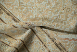 Close-up of distressed antique Malayer carpet, worn beige pile with powder blue Herati motif.
