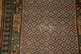 Detail of an antique Serab's blue lattice pattern showing visible foundation and intricate border.