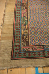 Antique Serab rug corner showing the pawn design border and wide camel outer band.