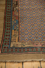 Reciprocating pawn design motif bordering the blue lattice field of an antique Serab runner.