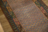 Close view of the antique Serab's low pile, with foundation showing through the lattice pattern.