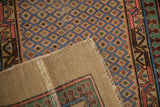A corner folded back reveals the ribbed foundation of this antique Persian Serab runner.