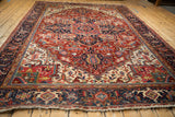 Angled perspective of a vintage Heriz carpet showing its oversized medallion and rich color palette.