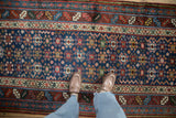 Geometric guls and serrated leaf borders on a richly colored antique Northwest Persian runner.