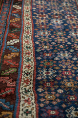 Low pile showing the serrated leaf border and geometric guls on the navy blue field.