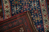 Corner detail of an antique Persian runner showing the woven foundation and side cord selvage.