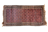 Vintage Kurd rug with an allover serrated leaf floral pattern in dusty burgundy and varying shades of blue.