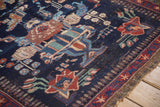 Red starburst meandering vine design on the minor border of the vintage Afshar rug.