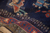Folded vintage Persian Afshar rug, showing rich navy field and a red starburst border design.