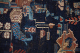 Vintage Afshar rug detail: deep navy field, folk art motifs in blues, red, and sand with minor foundation showing.