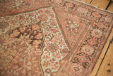 Angled view of a Farahan Sarouk corner spandrel, showing worn pile and hand-knotted texture.