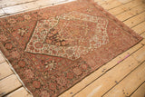Overhead perspective of an antique Farahan Sarouk rug, showing the full medallion, spandrels, and time-softened colors.