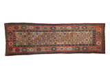 Antique Kazak runner with a starburst medallion lattice, framed by intricate floral and pawn motif borders.