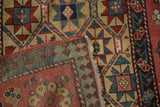 The dense hand-knotted foundation and intact selvage of an antique Kazak runner revealed at the corner.