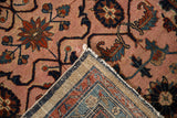 Folded corner of a vintage Persian rug showing the hand-knotted foundation and side selvage.