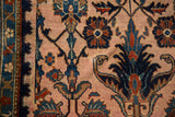 Close-up of hand-knotted texture showing intricate floral palmettes and arabesques.