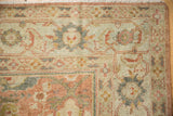 Softly worn texture on the corner of a vintage Mahal, showing its partial Herati border.