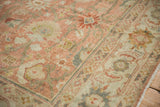 Angled view of the vintage Mahal's Herati border and palmette designs in dusty rose and silver.
