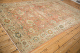 Soft polished wool and allover floral design of a vintage distressed Mahal carpet from an angle.