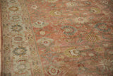 Evenly worn, low pile of a vintage Mahal carpet showing dusty rose and platinum floral details.
