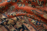 Soft, draping folds reveal the plush hand-knotted pile of a vintage Persian Sarouk carpet.