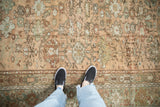 Even wear and low pile texture of a vintage Ghiordes carpet with allover floral motifs.