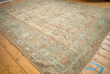 Angled perspective of a distressed Turkish Ghiordes rug with its time-softened botanical field.