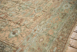 Mostly even wear to the knot heads on a distressed vintage Ghiordes rug with floral details.