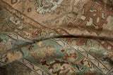 Pliable hand-knotted texture of a distressed Ghiordes carpet showing even wear and floral details.