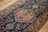 Dusty rose stepped medallion and navy blue field with germinating blossoms, vintage Heriz runner.