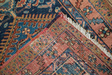 Vintage Heriz rug corner with hand knotted foundation, restored selvage, and white fringe.