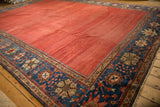 Antique Sultanabad corner, striated cochineal field, deep sapphire border with palmettes.