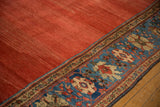 Striated cochineal red field to sapphire blue floral border on antique Sultanabad carpet.