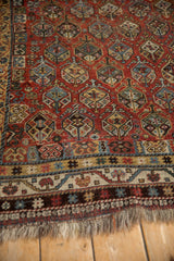 Antique Qashqai rug corner showing chestnut field's germinating shrub motif, distinct borders, and fringe.