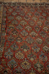 Textured hand-knotted pile showcasing germinating shrub motifs in dusty blue, green, and chestnut.