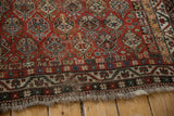 Intricate Qashqai geometric border in blue, green, and ivory, showing short fringe.