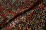 Antique Qashqai rug: germinating shrub motifs with meandering vine border, chestnut, green, blue.