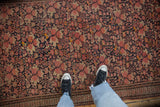 Antique Malayer rug with dusty blush floral bouquets on navy and germinating blossom border.