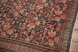 Dusty blush floral field and intricate germinating blossom border of an antique Malayer rug.