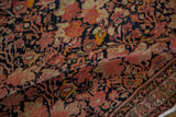 Antique Malayer rug close-up: dusty blush floral bouquets, germinating border, and pile wear.