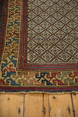 Intricate geometric border and lattice pattern on the corner of an antique Caucasian rug.